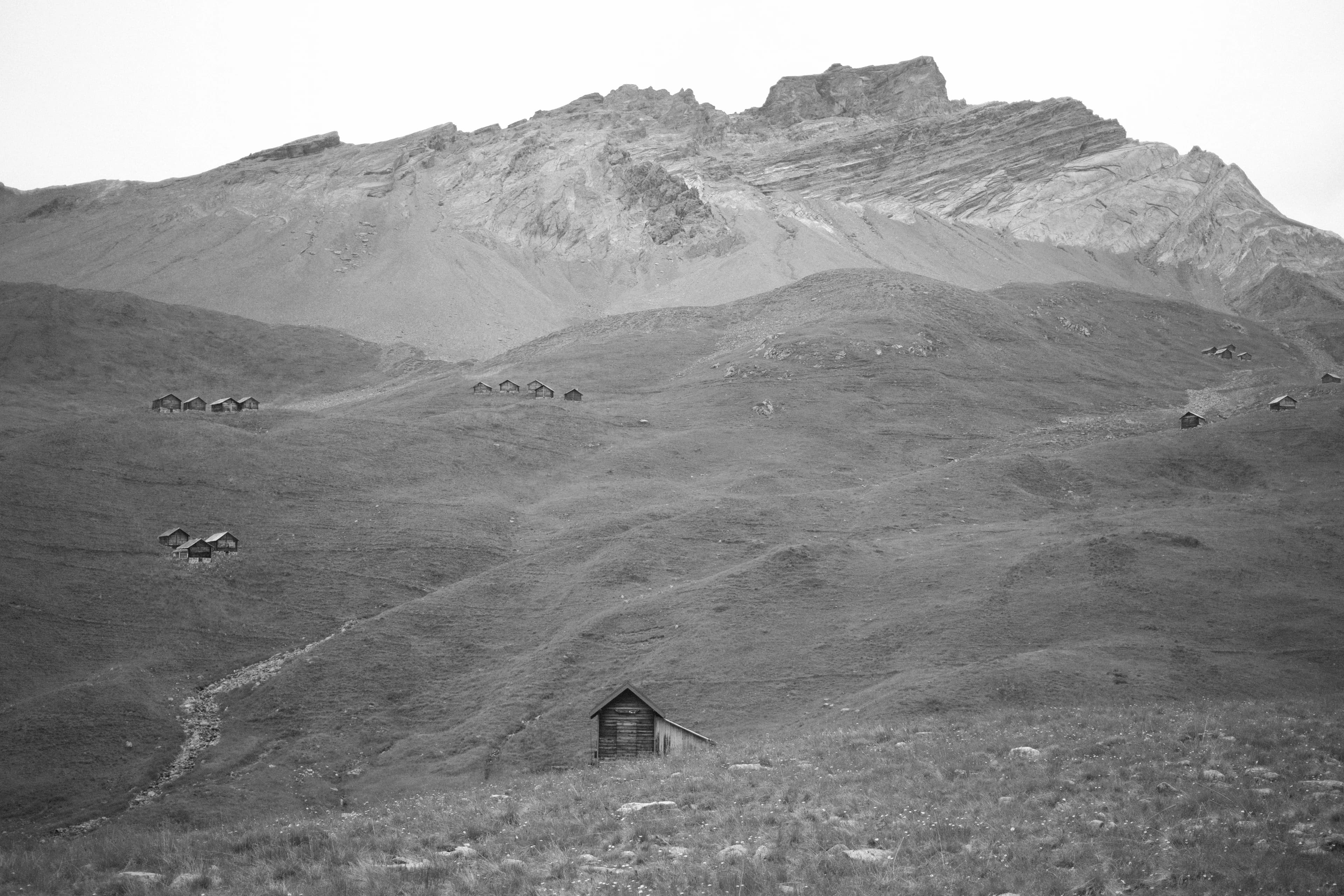 The same scene with several small huts dotted across the hillsides