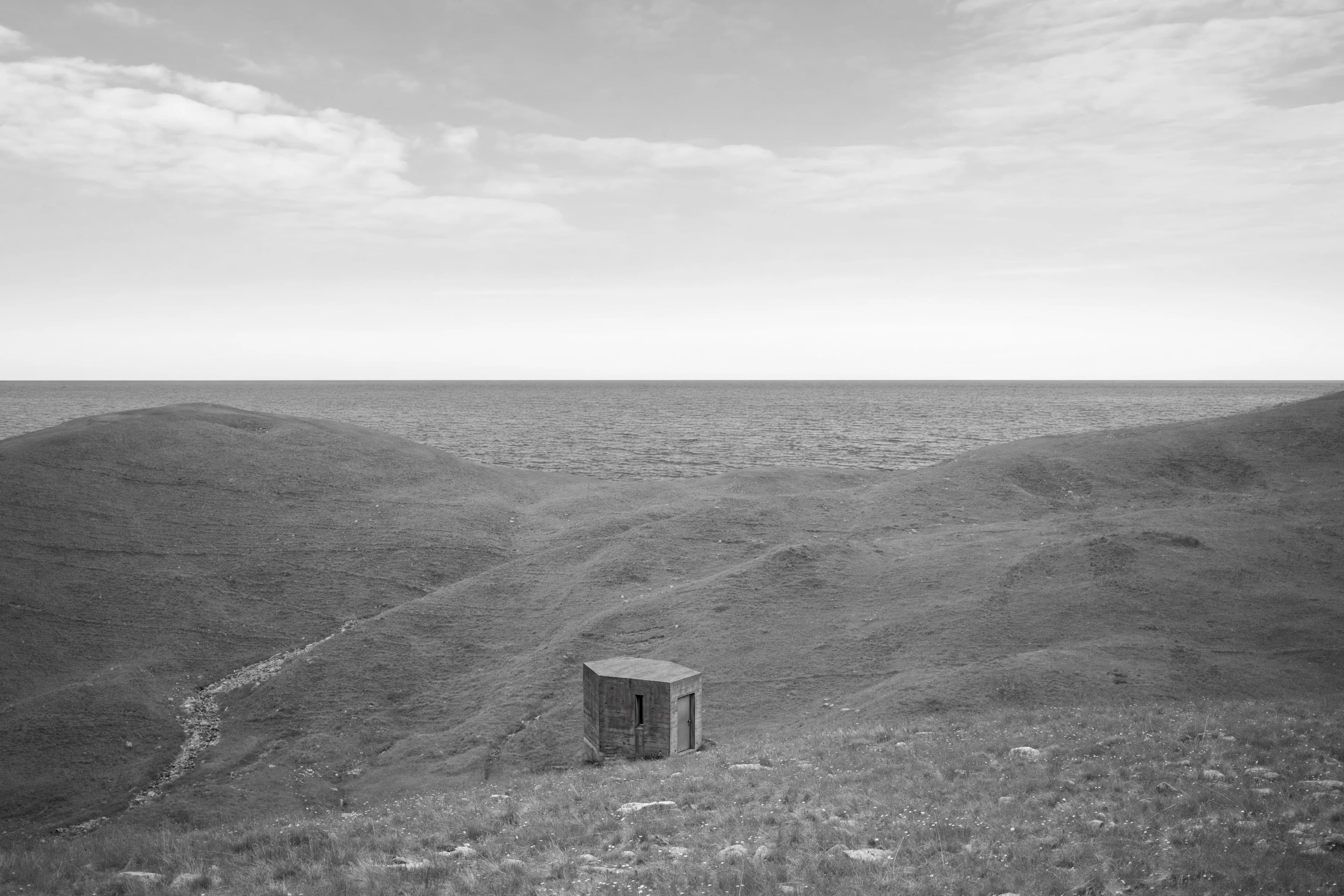 A concrete bunker on coastal hills above the sea